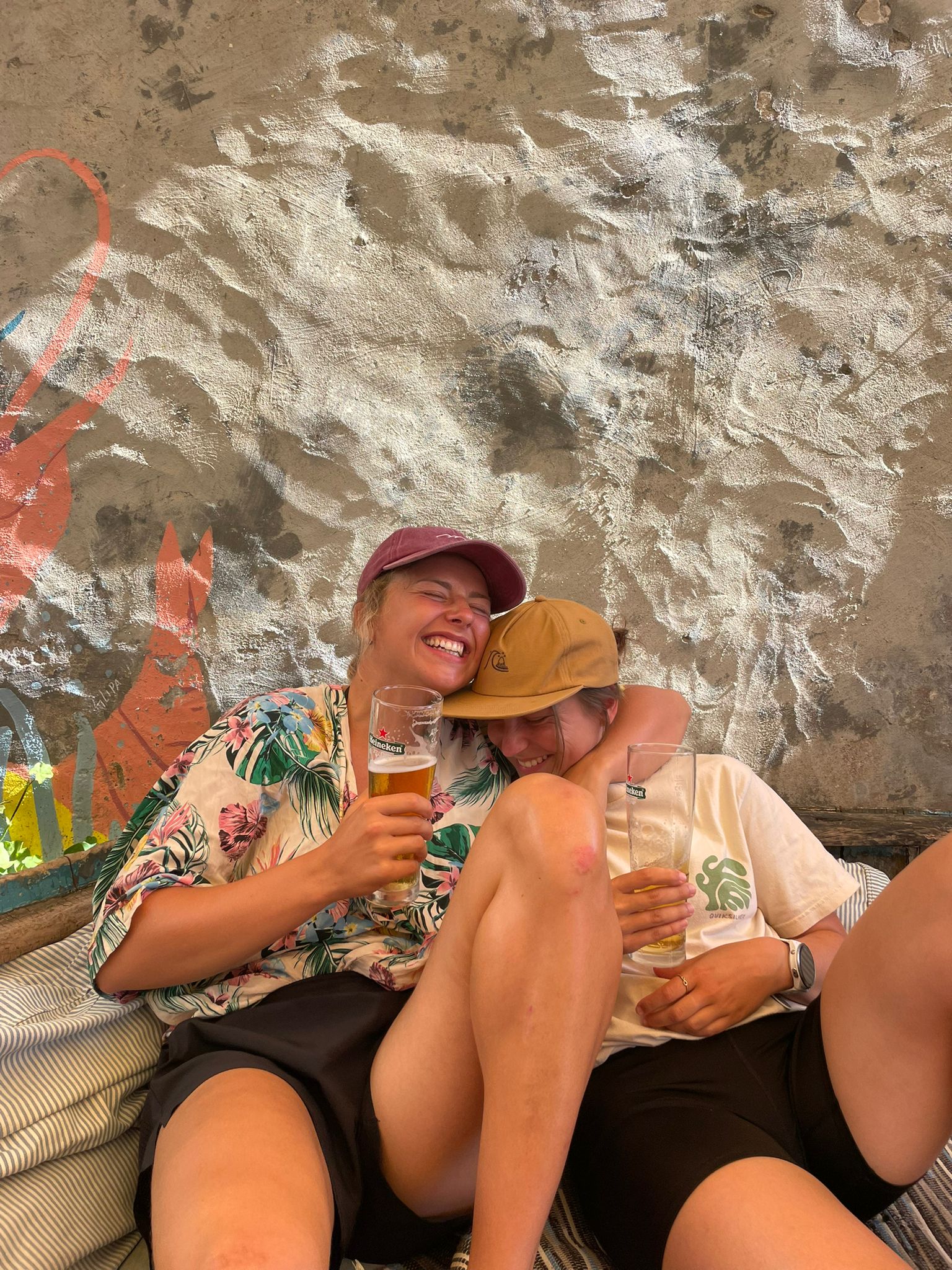 Friends laughing together — social side of surf lessons Porto and surf Portugal